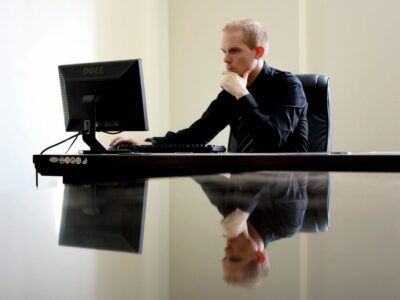 Man facing computer trying to make a decision