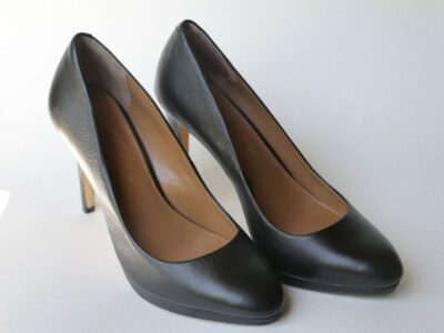 A pair of black, high-heeled shoes worn by most women at work.