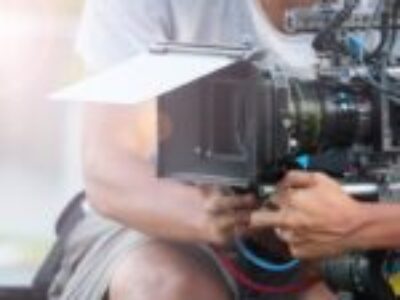 a man adjusting the camera in a video production business in the US
