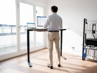 A tall man standing on his desk