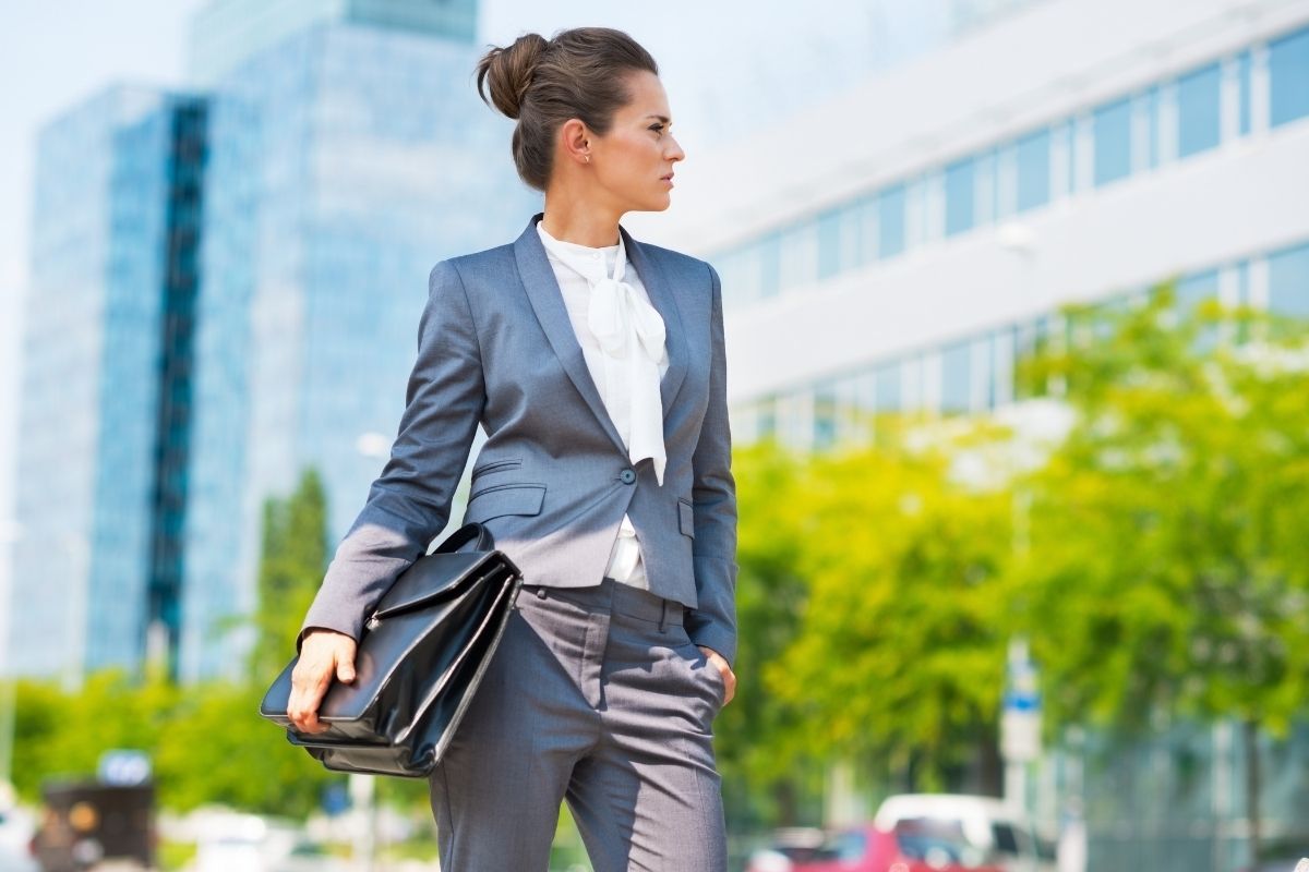 Beautiful middle aged woman holding her briefcase and wearing clean office attire