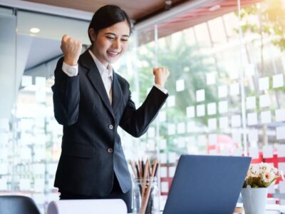A woman in a business attire who seemed to be very happy.