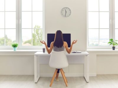 The woman feels relaxed while working in an office with zen decor.